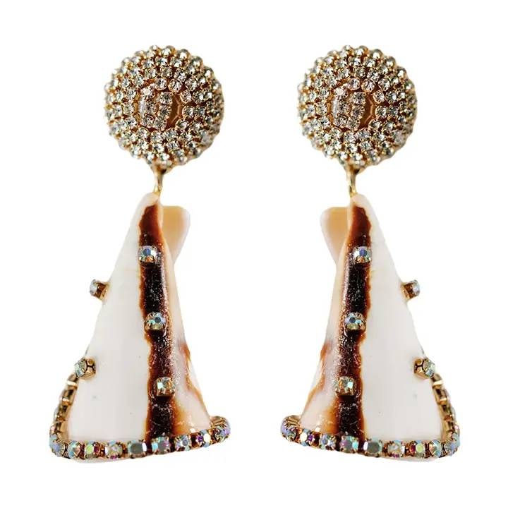 STRIPED SHELL STATEMENT EARRINGS: Elevate your summer style with our Natural Shell Statement Earrings, delicately wrapped in rhinestones and suspended from a shimmering rhinestone-wrapped base. Perfect for summer evenings and exotic v