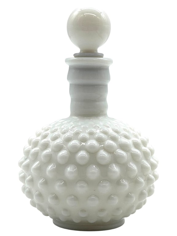 MILK GLASS HOBNAIL DECANTER 6": White milk glass decanter featuring an all-over hobnail pattern with a ribbed neck and matching round ball stopper. The opaque white finish and classic mid-century styling make this an attractive deco
