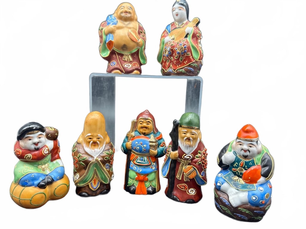 7 Japanese Kutani Porcelain Figurines: 7 Japanese Kutani porcelain figurines depicting the Seven Lucky Gods, each brightly hand-painted. Figurine heights range around 3.5 to 4 inches. Fine painted details and traditional attire featured