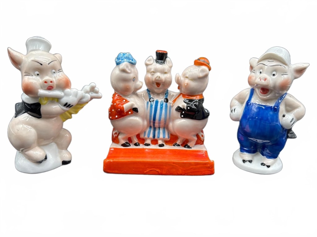 Disney Three Little Pigs Porcelain Figurines: Porcelain figurines depicting Disney's Three Little Pigs, including stamped markings and Walt Disney copyright. Includes individual and grouped figures on a red base. Registered as No. 801 463. Foreig