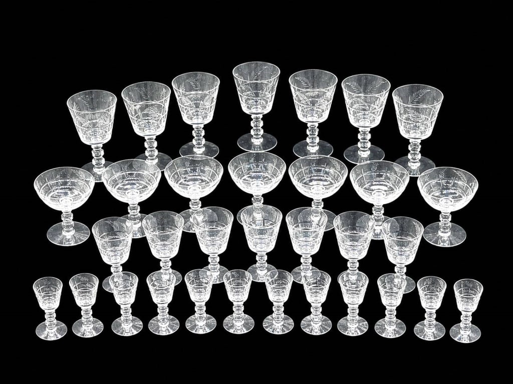 TIFFIN-FRANCISCAN CHATHAM ETCHED STEMWARE 7": This 36-piece collection of vintage Tiffin-Franciscan crystal stemware features the elegant No. 17301 Chatham etched pattern with delicate floral and foliate engraving. The lot includes eight water go
