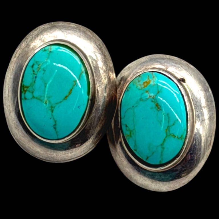 MEXICO STERLING TURQUOISE CLIP EARRINGS: Vintage Mexican sterling silver clip-on earrings featuring vibrant oval turquoise cabochons with natural matrix, bezel set within substantial polished sterling silver frames. The classic oval silhouet