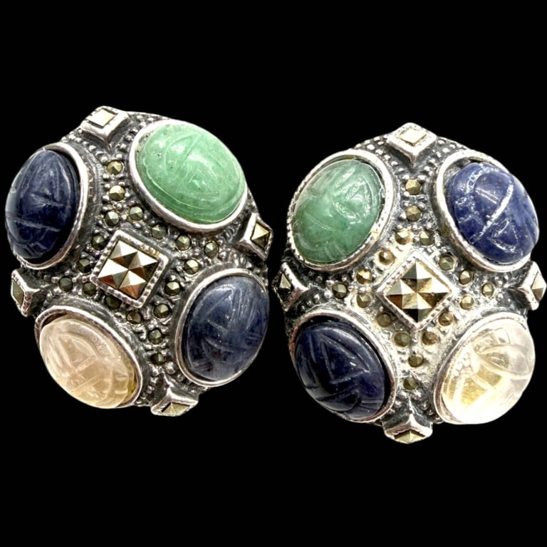 STERLING SCARAB & MARCASITE CLIP-ON EARRINGS: Vintage sterling silver clip-on earrings featuring an elegant domed design set with four carved scarab gemstones in shades of deep blue, translucent clear, and soft green. Each scarab is bezel set amo