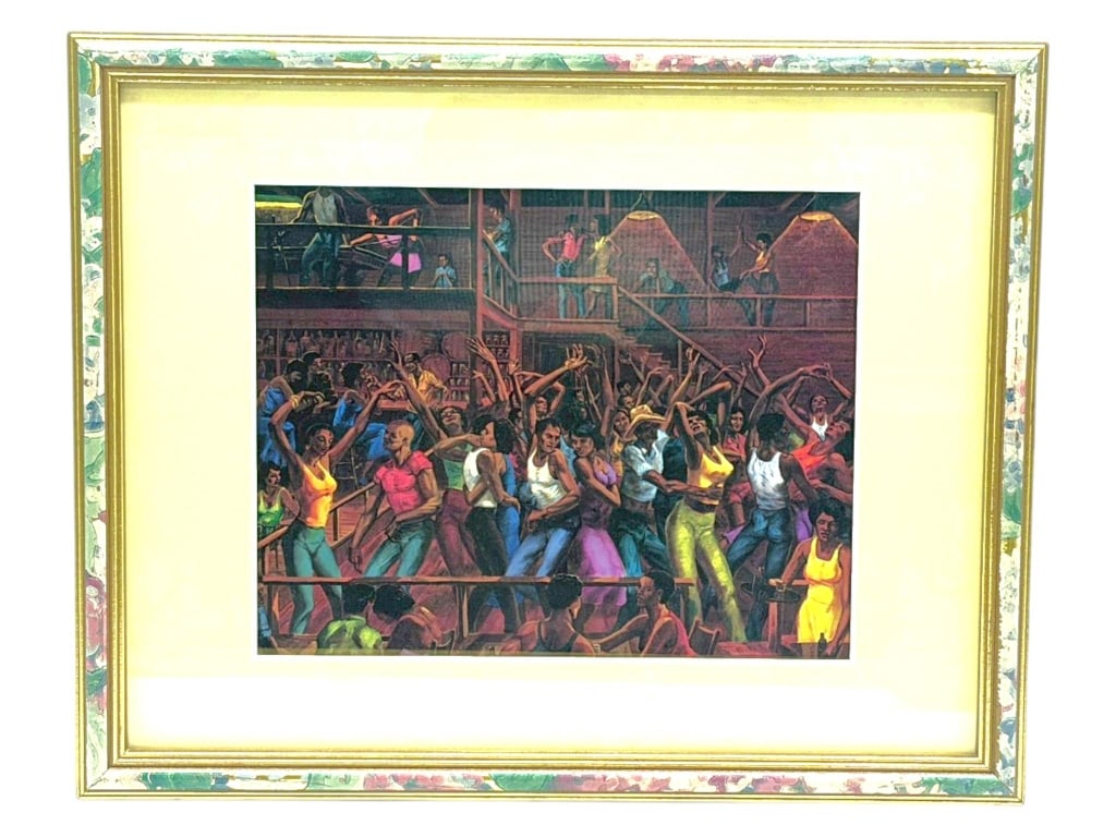 FRAMED DANCE HALL PRINT 25": This framed decorative print depicts a lively dance hall scene filled with energetic figures dancing beneath warm interior lighting. Richly colored in deep earth tones with vibrant accents, the compos