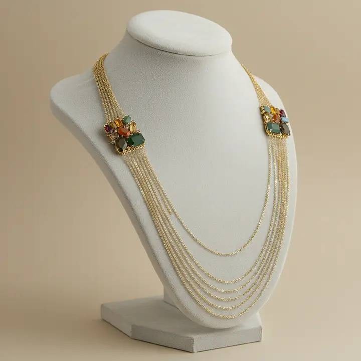 Multistrand Gold Tone Necklace With Gem Accen: This exquisite vintage-inspired necklace features multiple layers of sparkling crystals, each connected by delicate gold-plated chains. Perfect for adding a touch of sophistication to your outfits, it