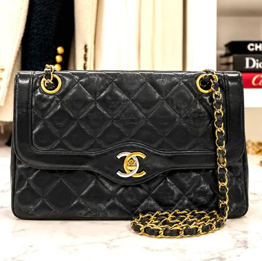 CHANEL RARE VINTAGE 1980S QUILTED FLAP BAG 9": Timeless and iconic Chanel Classic Flap shoulder bag crafted in supple black quilted leather with signature diamond quilting, an elegant leather-woven chain shoulder strap, and the iconic 24K gold-pla