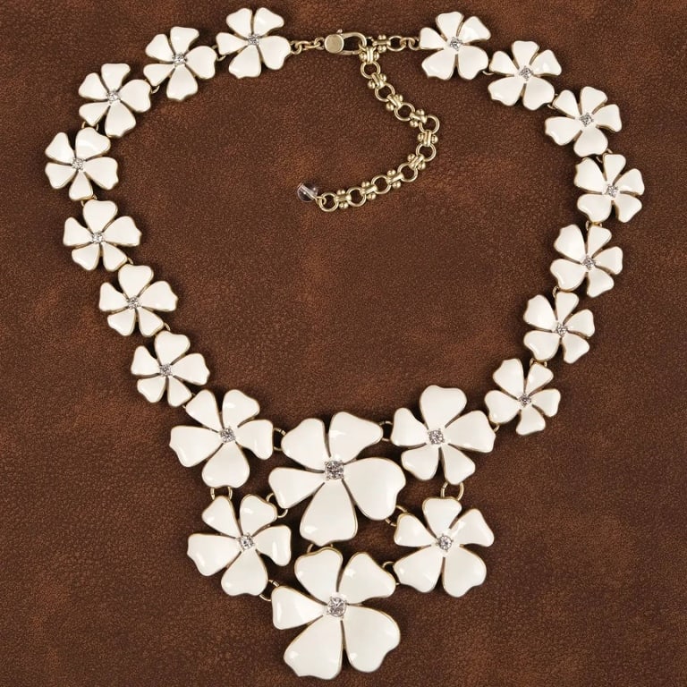 VINTAGE 18K GP WHITE FLORAL NECKLACE: This charming necklace features a delicate arrangement of white enamel flowers, each adorned with sparkling crystal centers. The18K GP chain adds a touch of elegance, making this piece a perfect blend