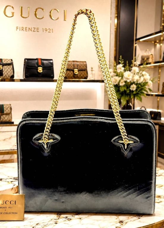 GUCCI 1970S VINTAGE PATENT CHAIN BAG 12": Elegant vintage Gucci structured shoulder bag crafted in glossy black patent leather with polished gold-tone chain shoulder straps. This sophisticated Italian-made design features a clean architectura