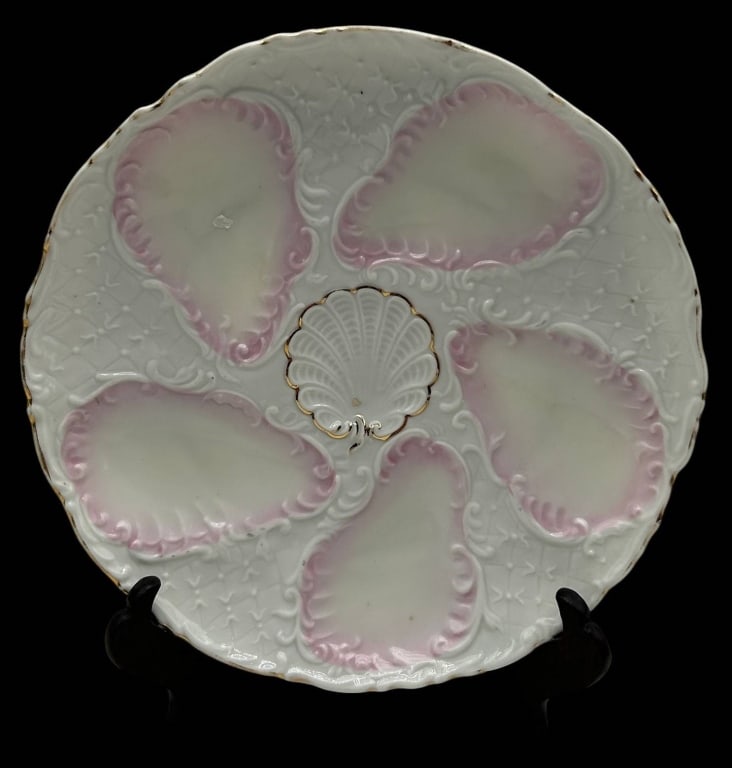 ANTIQUE OYSTER PLATE PINK LUSTER 8": Beautiful antique porcelain oyster plate featuring five generously molded oyster wells surrounding a raised central shell-form sauce well. The elegant design is enhanced with delicate blush pink luste