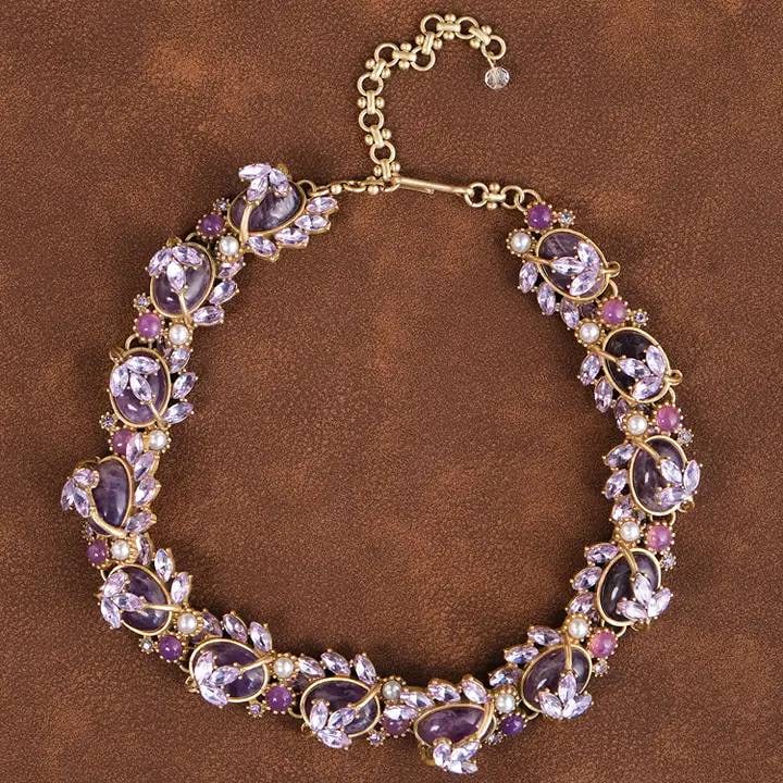 VINTAGE 18K GP PURPLE STATEMENT NECKLACE: Crafted with timeless elegance, this statement necklace features faceted purple crystals, shimmering crystals, and delicate pearl accents. Set in a vintage-inspired gold-tone design, each detail adds 