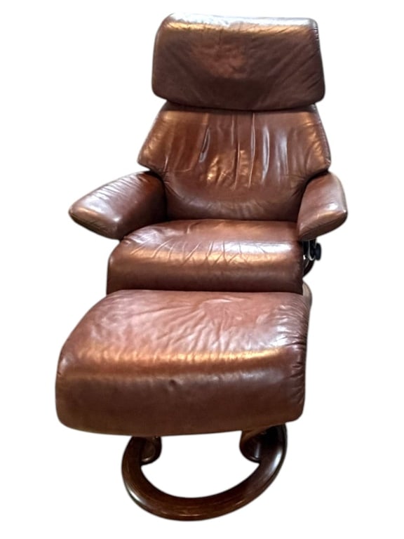 STRESSLESS RENO MEDIUM LEATHER RECLINER 39": Norwegian Stressless by Ekornes reclining lounge chair with coordinating ottoman, attributed to the classic Reno model in the factory Medium size. The chair is upholstered in warm cognac-brown leather