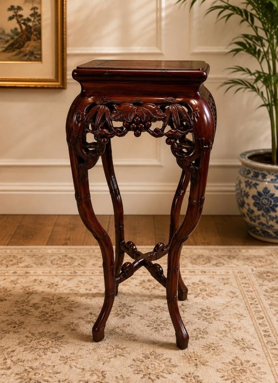 CARVED ASIAN HARDWOOD PEDESTAL STAND 37": Elegantly hand carved hardwood pedestal or plant stand featuring intricate openwork grapevine, leaf, and berry motifs with gracefully curved cabriole legs joined by an X-form stretcher. The richly fin