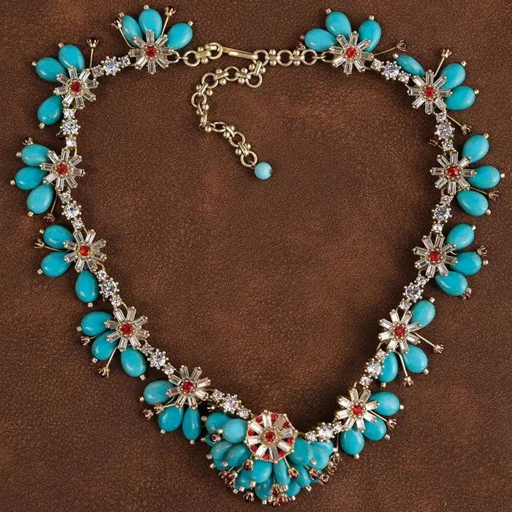 VINTAGE 18K GP TURQUOISE NECKLACE: This stunning statement necklace features vibrant turquoise stones arranged in elegant floral patterns, accented with sparkling crystals and 18K GP details. | | The necklace measures 17 + 3.5 inches