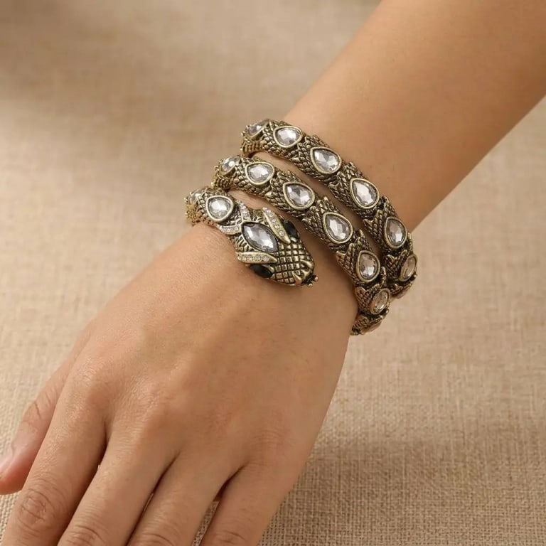 VINTAGE SERPENTINE WINDING CRYSTAL BRACELET: This stunning vintage snake bangle features an array of sparkling crystals set in a luxurious gold-plated design. The intricate details give it a timeless and glamorous appeal, perfect for adding a to