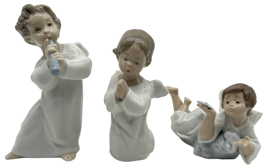 3 LLADRO ANGEL FIGURINES 6": Charming collection of three authentic Lladr? porcelain angel figurines, each hand crafted in Spain and finished in the brand's signature soft pastel palette. The lot includes an angel playing a recor