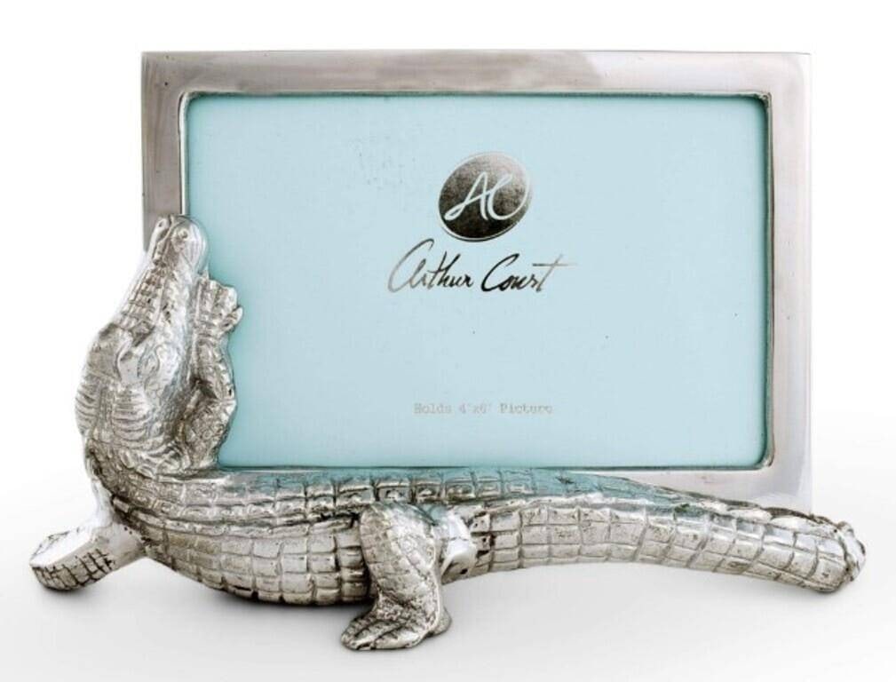 NEW IN BOX ARTHUR COURT ALLIGATOR FRAME: A sneaky alligator crawls along the bottom of this piece, arching its head up for a quick look at the people in this picture. Handcrafted in sand-cast aluminum, this frame's gleaming finish contrasts 