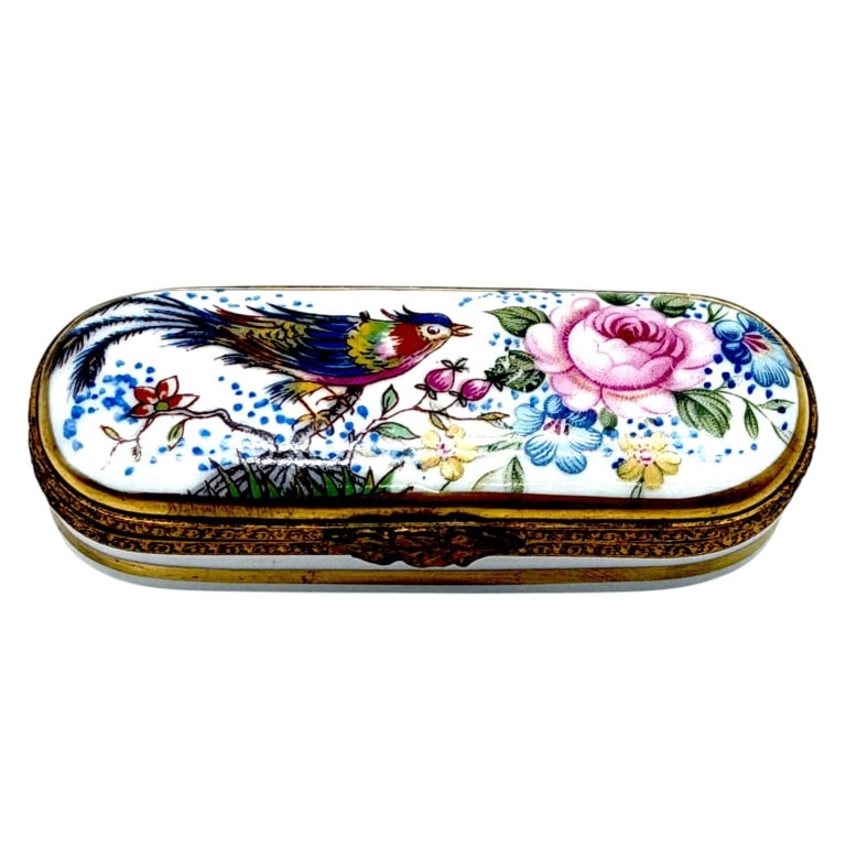 LIMOGES TROPICAL BIRD PORCELAIN BOX 2": This elegant hand-painted Limoges porcelain trinket box features a graceful elongated rectangular form decorated with a brilliantly colored songbird perched among blooming pink roses, blue blossoms, a