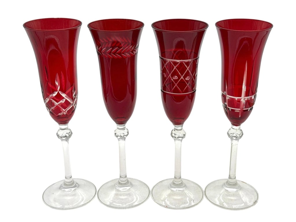 4 RUBY CUT TO CLEAR CRYSTAL CHAMPAGNE FLUTES 9": Elegant set of four vintage ruby red overlay champagne flutes, each featuring a unique cut-to-clear decorative motif with clear faceted knop stems. The collection includes four complementary yet disti