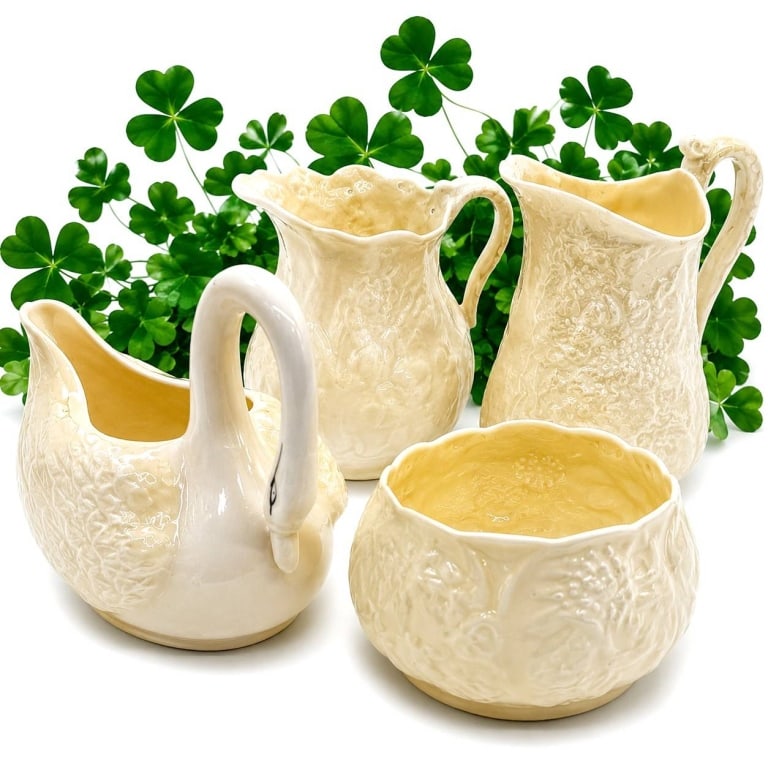 BELLEEK IRISH PORCELAIN TABLEWARE LOT 7": This charming lot of four Belleek Irish porcelain table accessories showcases the classic basketweave and embossed shamrock designs that have made Belleek one of Ireland's most celebrated porcelain ma