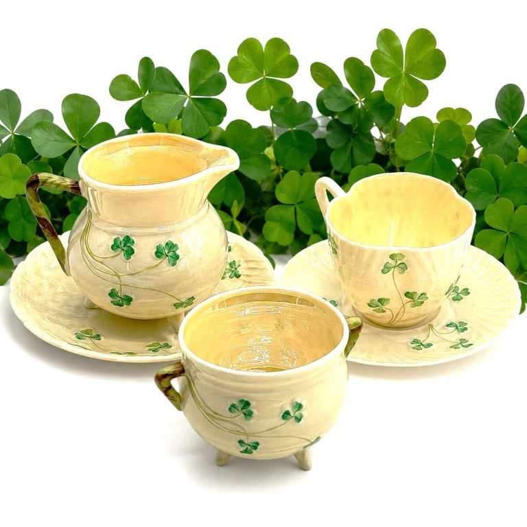 BELLEEK SHAMROCK IRISH PORCELAIN TEA LOT 5": This charming Belleek Irish porcelain tea service lot showcases the timeless Shamrock pattern in Belleek's signature lustrous ivory porcelain. The grouping includes a miniature creamer with matching u