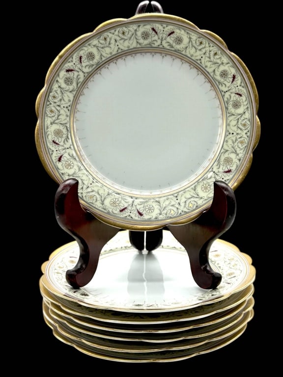 SET OF 6 LIMOGES STYLE GILT DINNER PLATES 11": A set of six porcelain dinner plates featuring an elegant scalloped rim with raised gilt edge and an intricately decorated border of scrolling foliate ornament accented by hand-applied gold and burgun