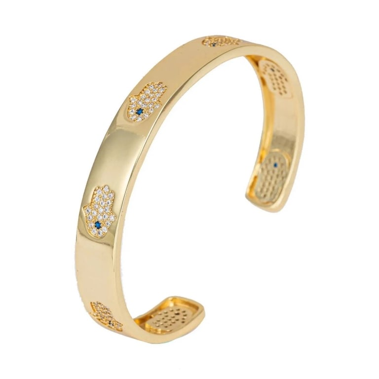 NEW EYE CANDY ANNA CUFF BRACELET: This cuff bracelet features a sleek gold color that is accompanied by small hamsa hands engraved in the lining of the band. This one of a kind gold bracelet can be worn formally or casually, which mak