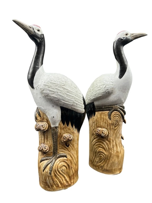 PAIR CHINESE JINGDEZHEN PORCELAIN CRANES 16": PAIR CHINESE JINGDEZHEN PORCELAIN CRANES 16" | | Pair of Chinese Jingdezhen porcelain crane sculptures, each modeled as a red-crowned crane perched upon a stylized tree-trunk pedestal decorated with c