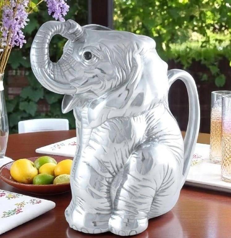 NEW ARTHUR COURT ELEPHANT PITCHER NEW W/O BOX: Lounge and enjoy the striking realism of Arthur Court's Elephant Pitcher. Mirroring a dog's obedient posture, this elephant sits on its hind legs, patiently waiting for someone to grab the handle on i
