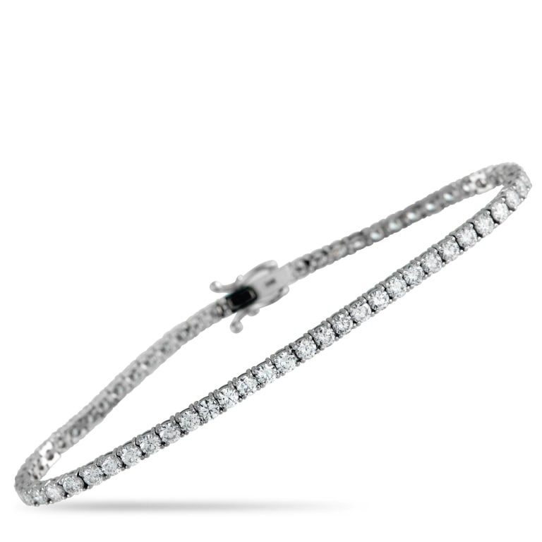 14K WHITE GOLD 5.05CT LAB-GROWN DIAMOND TENNIS BRA: Add a touch of luxury to any ensemble with this tennis bracelet. The understated 14K White Gold setting allows Lab Grown Diamonds totaling 5.05 carats to take center stage. This elegant accessory meas