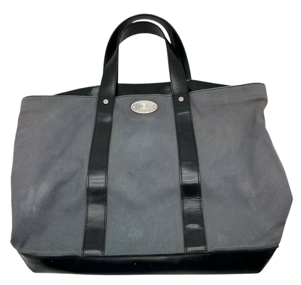 CELINE GRAY CANVAS TOTE 16": Elegant Celine tote crafted in durable gray canvas with smooth black leather trim, rolled leather handles, and polished silver-tone Celine logo plaque. This generously sized tote features a structured