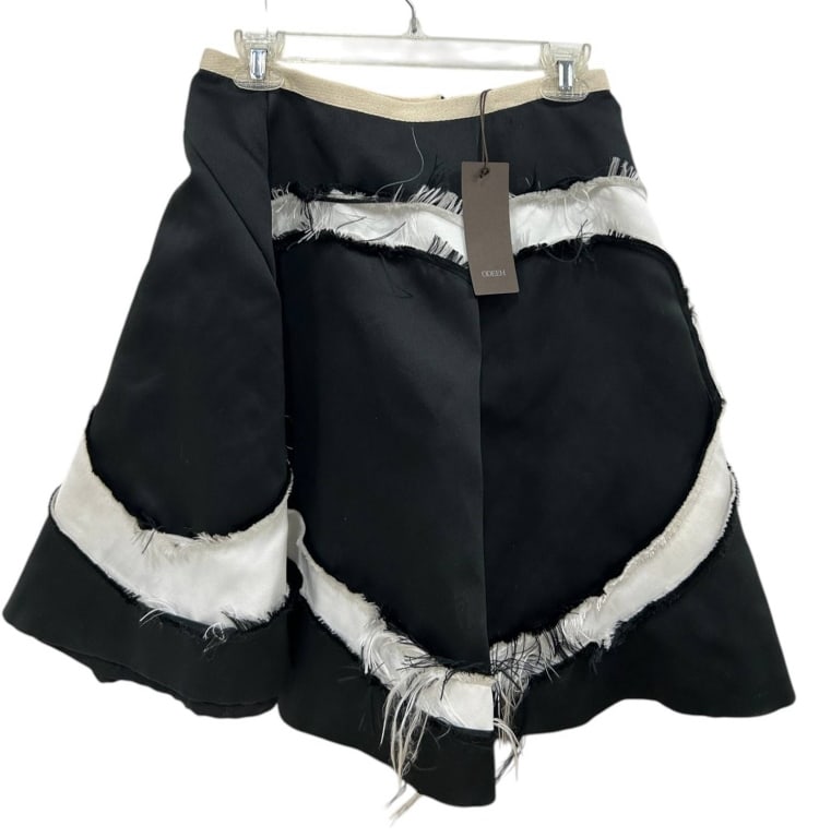 ODEEH AVANT-GARDE FRINGED SKIRT 38: Designer ODEEH avant-garde black skirt featuring an architectural A-line silhouette with dramatic raw-edge ivory satin appliqu? in an abstract sweeping motif. Constructed of 100% polyester shell with 