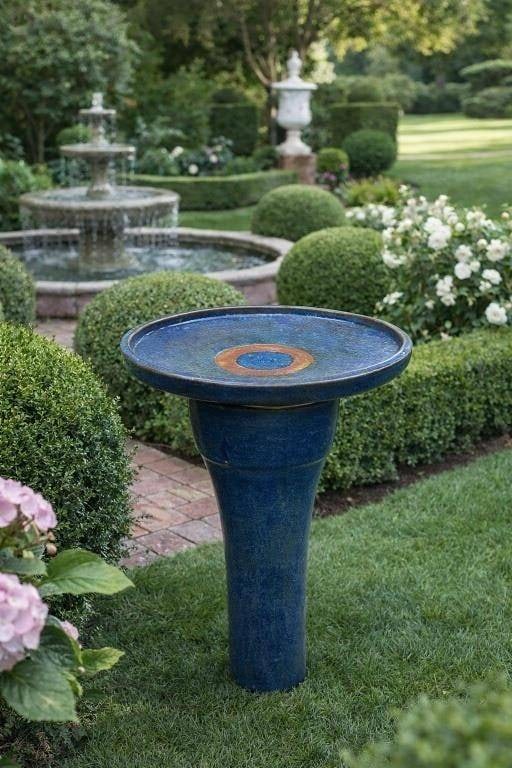 BLUE GLAZED POTTERY PEDESTAL BIRD BATH 31" TALL: BLUE GLAZED POTTERY PEDESTAL BIRD BATH 31" TALL | | Handcrafted pottery bird bath featuring a rich cobalt blue glaze with subtle tonal variation and natural kiln effects throughout. Designed with a wi