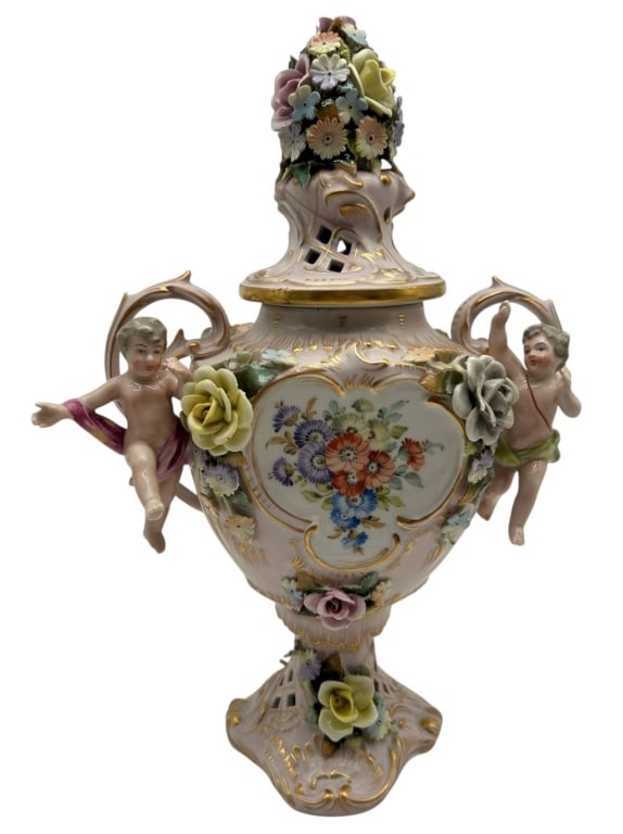 VON SCHIERHOLZ FLORAL PORCELAIN URN 13": Elaborate German porcelain covered urn by Von Schierholz, richly decorated with hand-painted floral bouquets, extensive applied porcelain flowers and ornate gilt Rococo-style detailing. The baluster-f