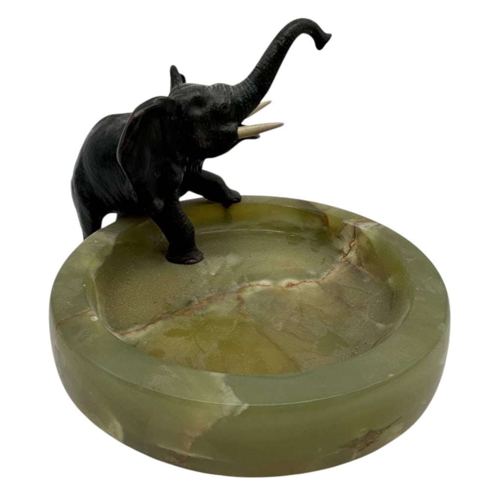 RONZE ELEPHANT ON GREEN ONYX ASHTRAY 8": Charming vintage decorative ashtray or desk accessory featuring a sculptural bronze-tone elephant mounted along the edge of a substantial polished green onyx bowl. The elephant is modeled with its tru