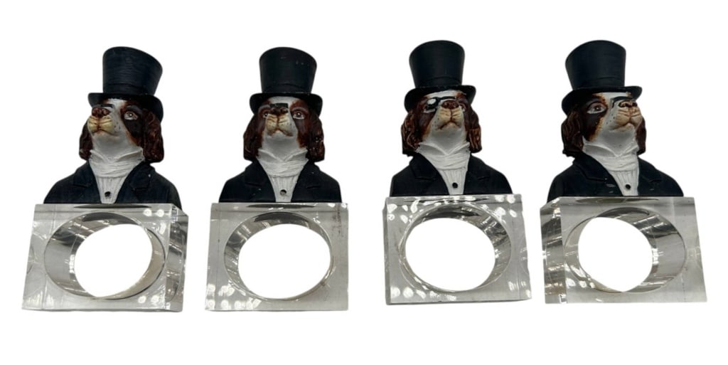SET OF 4 FIGURAL DOG NAPKIN RINGS 4": Charming set of four figural dog-form napkin rings, each featuring a distinguished spaniel-type dog dressed as a gentleman in a black top hat, formal jacket and white shirt. Each hand-painted figural 