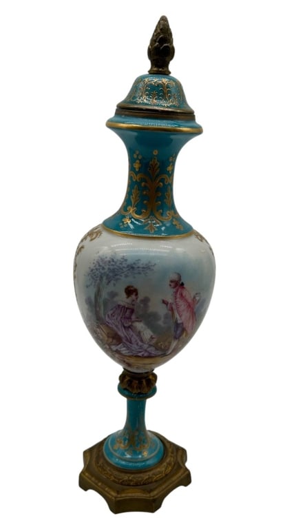 SEVRES STYLE PORCELAIN COVERED URN 13": Elegant French porcelain covered urn in the S?vres style, featuring a turquoise blue and white ground richly embellished with hand-painted gilt ornamentation. The central reserve depicts an 18th-centu