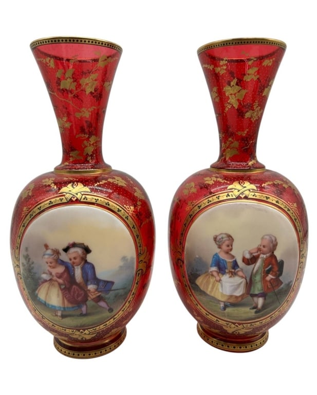 PAIR CRANBERRY GLASS PORTRAIT VASES 9.5": Elegant pair of cranberry glass vases featuring rich translucent ruby-cranberry bodies embellished with extensive hand-painted gilt decoration. Each vase displays a finely rendered oval portrait scene