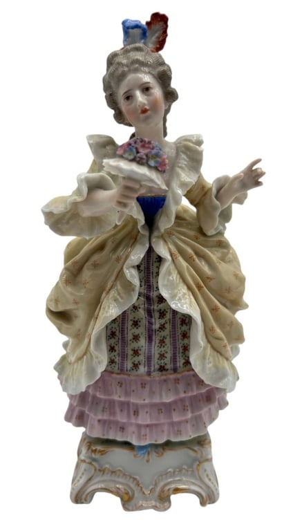ANTIQUE PORCELAIN LADY WITH FLOWERS 10": Elegant antique Continental porcelain figurine depicting a fashionable 18th-century lady holding a bouquet of colorful applied flowers. Beautifully modeled in an elaborate period gown with a cream ove
