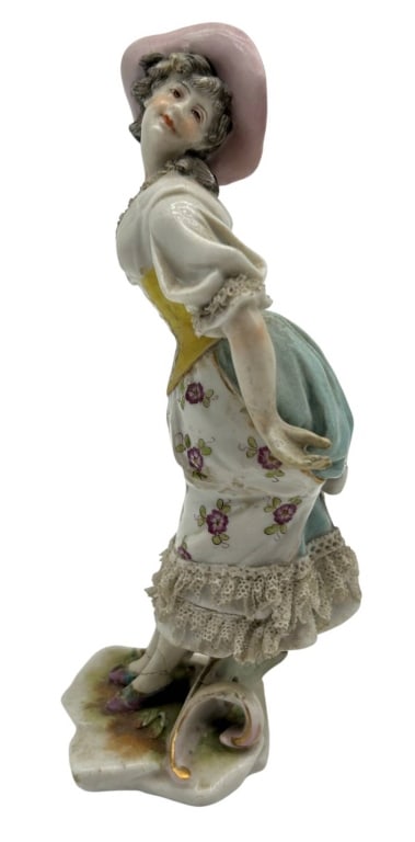 ANTIQUE PORCELAIN LACE LADY FIGURINE 6": Antique Continental porcelain figurine depicting an elegant young woman in a dramatic posed stance, wearing a pale pink bonnet, yellow corseted bodice, floral-decorated skirt, and delicate applied por