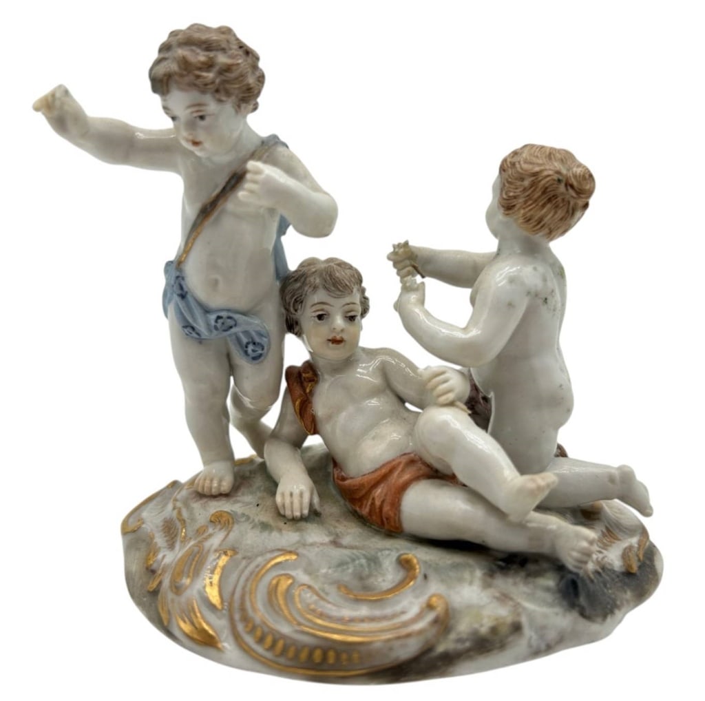 ANTIQUE GERMAN PORCELAIN THREE CHERUBS 4": Charming antique German porcelain figural group depicting three playful cherubs or putti arranged upon an ornate Rococo-style base. Each figure is individually modeled with hand-painted facial feature