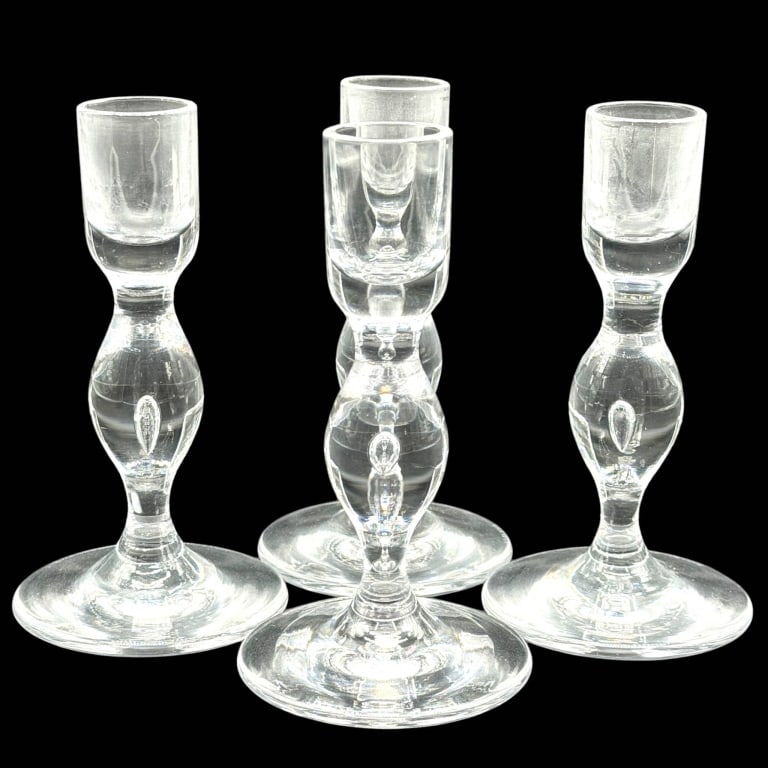 4 VICKE LINDSTRAND X KOSTA BODA CANDLESTICKS 5": Set of four vintage Swedish clear crystal candlesticks by Vicke Lindstrand (1904?1983) for Kosta, displaying the elegant Scandinavian Modern aesthetic for which the celebrated glass designer is known.