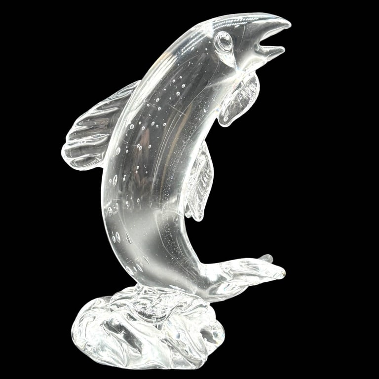MURANO STYLE CLEAR ART GLASS LEAPING FISH 8": Vintage hand-blown clear art glass sculpture depicting a dramatic leaping fish rising vertically from a sculpted wave-form base. The elongated body is accented with numerous suspended air bubbles, whi