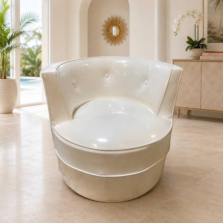 MID CENTURY WHITE VINYL BARREL CHAIR 29": Vintage mid-century modern barrel chair featuring a rounded tub-form silhouette upholstered in glossy white vinyl. The wraparound back is accented with three covered buttons, while contrasting piping 