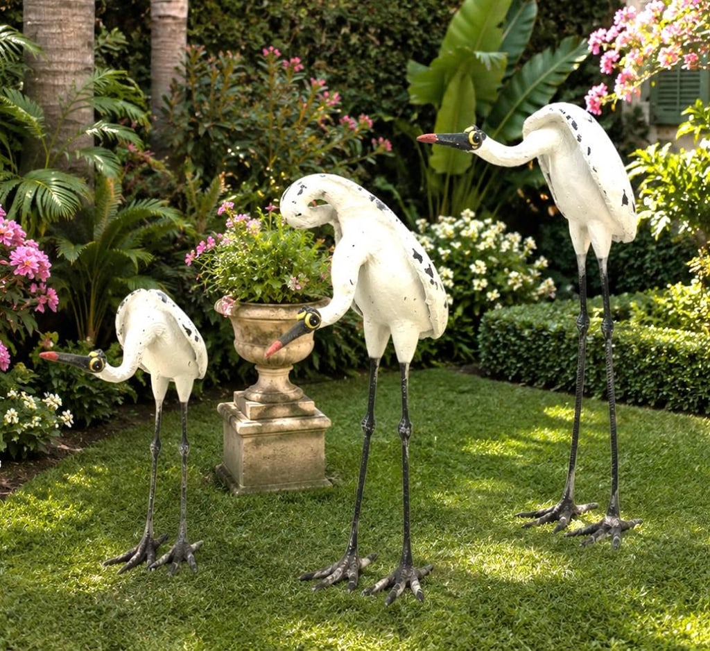 TODD WARNER SET OF THREE SAND CRANE GARDEN SCULPTU: This whimsical set of three sculptural sand cranes by celebrated American artist Todd Warner features the artist's signature blend of playful design and handcrafted character. Constructed with elongat