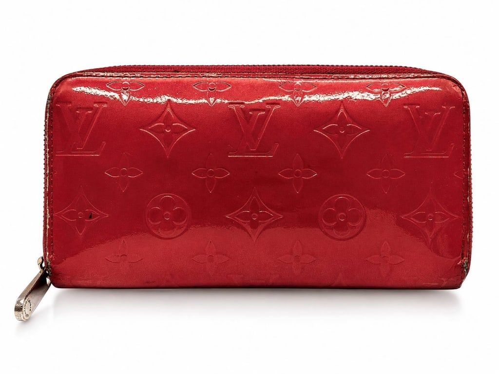 LOUIS VUITTON MONOGRAM VERNIS ZIPPY WALLET 8": Louis Vuitton Zippy Wallet crafted in Rouge Grenadine Monogram Vernis patent leather with embossed monogram pattern and polished silver-tone hardware. This iconic zip-around design features a leather-