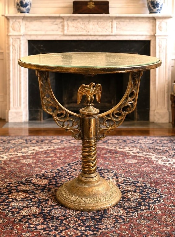 BRASS EAGLE PEDESTAL GLASS TOP TABLE 23": An elegant vintage brass accent table featuring an ornate pedestal base with decorative openwork supports and a finely cast eagle finial beneath a round glass top. The neoclassical-inspired design com