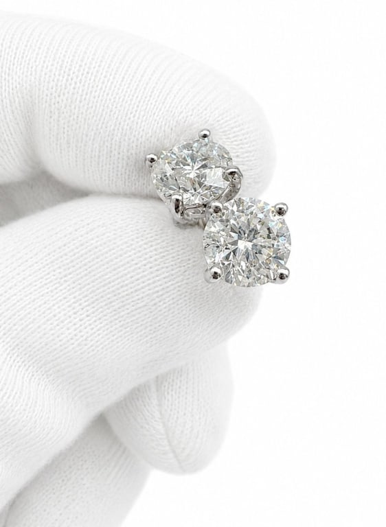 14K WHITE GOLD 2.00 CTW DIAMOND STUD EARRINGS: Pair of 14 karat white gold stud earrings set with two round brilliant-cut diamonds totaling approximately 2.00 carats. The diamonds are graded G-H color and I1-I2 clarity with excellent cut, polish, 