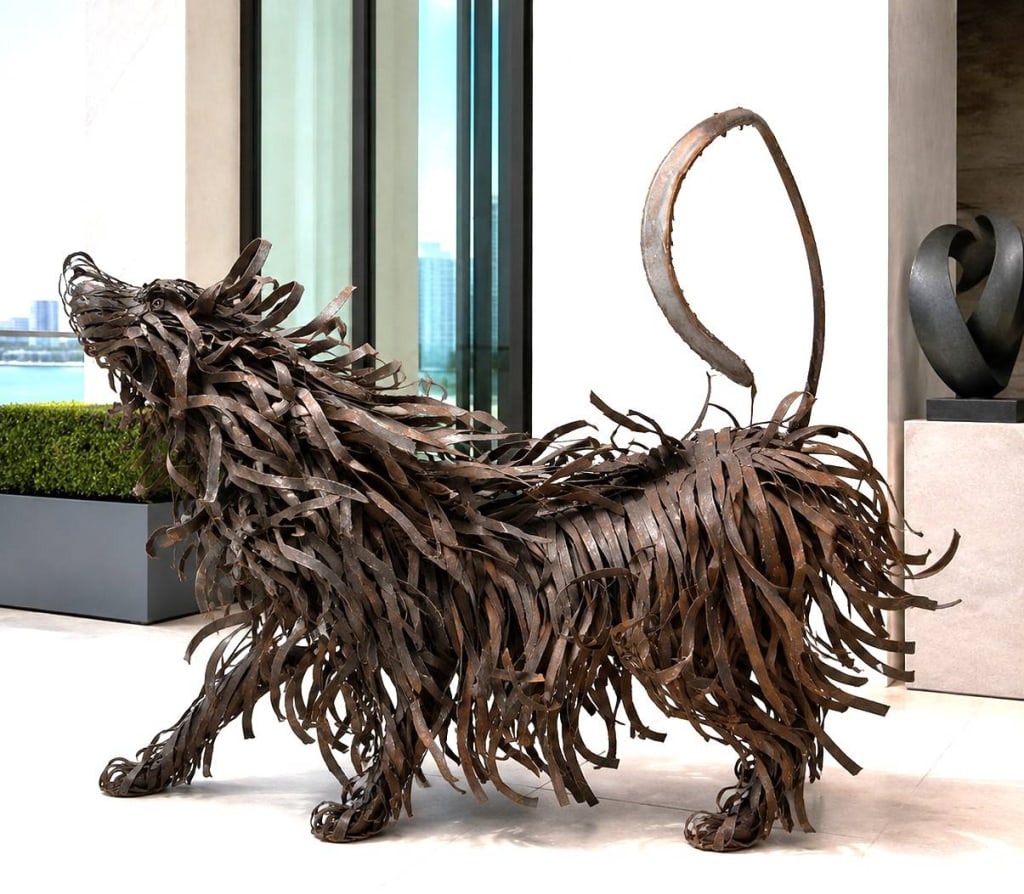 MONUMENTAL METAL SHEEPDOG SCULPTURE 57": Striking monumental hand-fabricated metal sculpture depicting a shaggy sheepdog captured in motion at the instant it vigorously shakes its body and coat. The artist has created an exceptional sense of