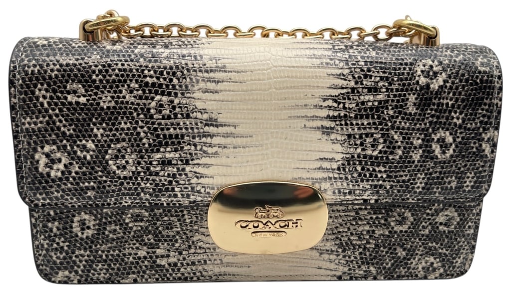 COACH LIZARD PRINT SHOULDER BAG 10?: This Coach shoulder bag features an eye-catching black, cream, and ivory lizard print exterior accented by polished gold-tone hardware. The structured silhouette is highlighted by a prominent Coach lo