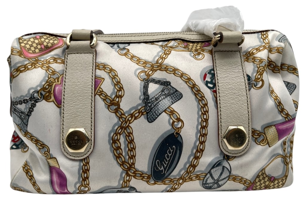 GUCCI SILK CHAIN PRINT SHOULDER BAG 12?: This Gucci shoulder bag features a whimsical silk fabric exterior decorated with signature Gucci-inspired motifs including chain links, handbags, shoes, and logos in a colorful fashion-themed print. T